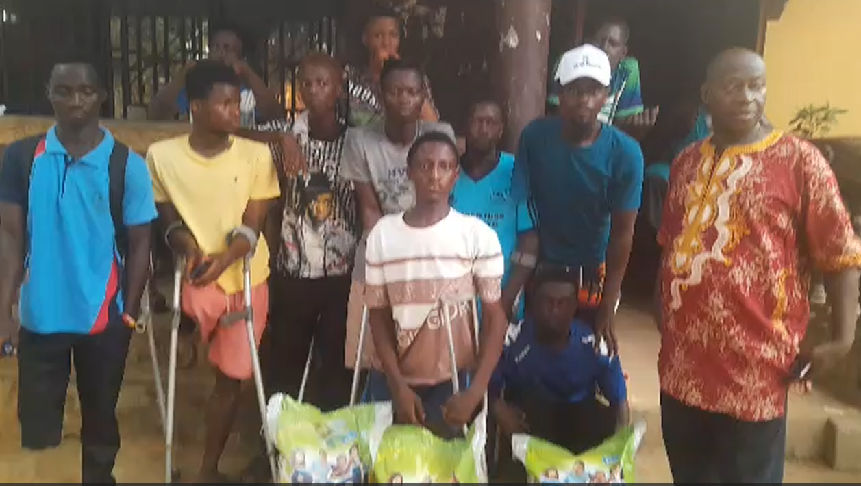 Amputee men at the Waterloo shelter receiving food support from Sitis Christi