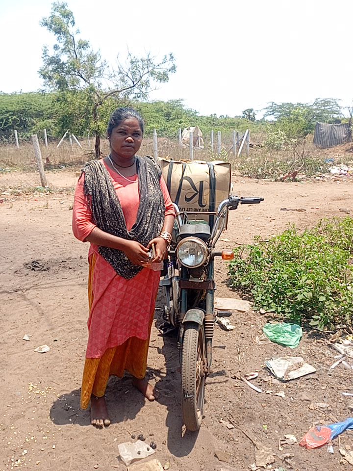 Sonia standing with her motorbike in Pondicherry